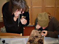 Inspecting earthstar fungi with jeweler's loupes in Private Eye lab with jeweler's loupes