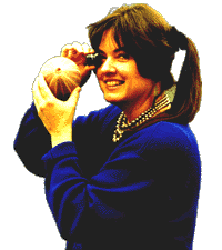 Kerry Ruef, founder and director of The Private Eye Project, holding a jeweler's loupe