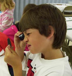 Student using a Private Eye Jeweler's Loupe in Afterschool Programming